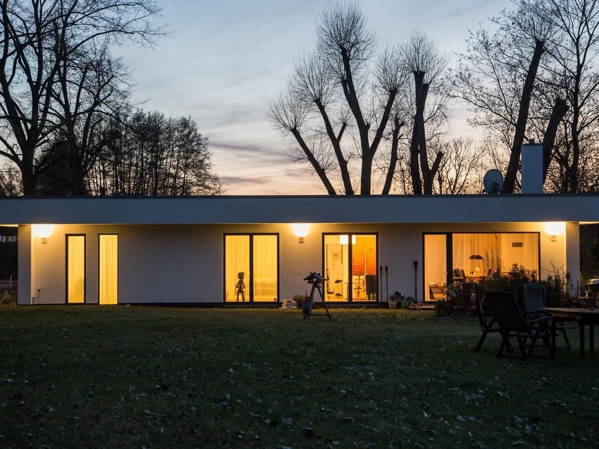 Flachdachbungalow bei Abenddämmerung